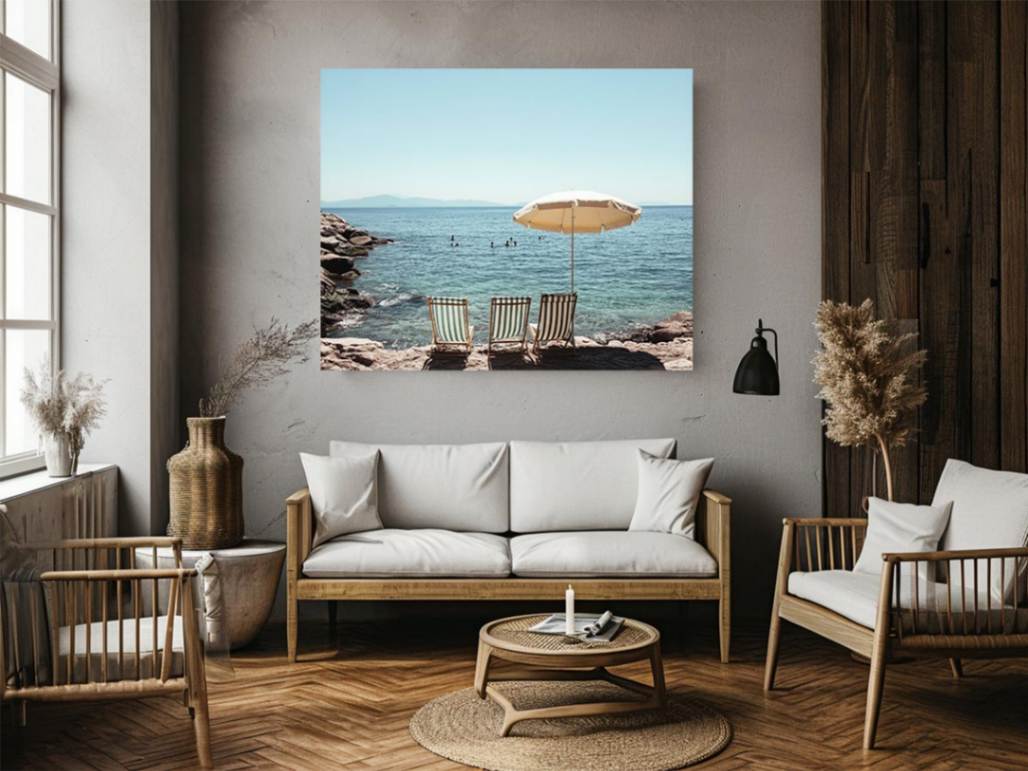 Beach chairs and umbrella overlooking calm sea for coastal decor