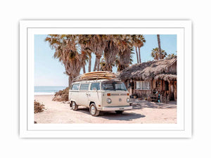 Cream vintage surf van near a palm beach hut for rustic coastal living room decor.
