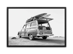Black and white vintage woody surf wagon with boards for classic coastal wall art.