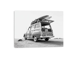 Black and white vintage woody surf wagon with boards for classic coastal wall art.