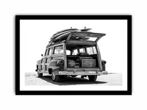 Black and white rear view of vintage woody wagon with surfboards for coastal decor.