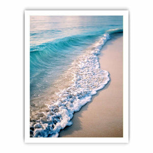 Soft turquoise ocean wave and sandy beach canvas art for coastal living room decor.