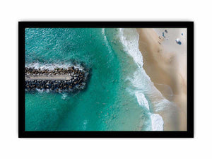 Turquoise beach drone print with swimmers and rock jetty for coastal living room decor