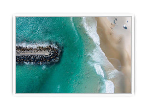 Turquoise beach drone print with swimmers and rock jetty for coastal living room decor