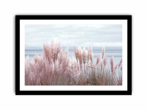 Soft blush pampas grass by the ocean as coastal botanical wall art for a serene bedroom.