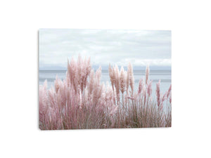 Soft blush pampas grass by the ocean as coastal botanical wall art for a serene bedroom.