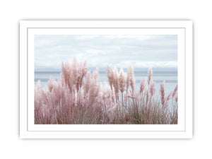Soft blush pampas grass by the ocean as coastal botanical wall art for a serene bedroom.