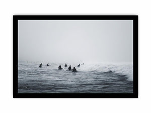 Moody surf canvas art with surfers and misty ocean waves for modern office decor.