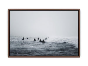 Moody surf canvas art with surfers and misty ocean waves for modern office decor.