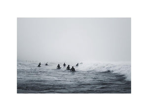 Moody surf canvas art with surfers and misty ocean waves for modern office decor.