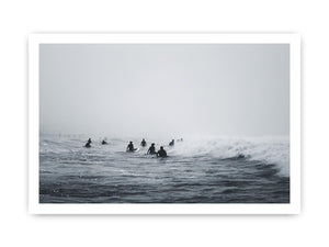 Moody surf canvas art with surfers and misty ocean waves for modern office decor.