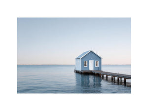 Blue boathouse over water artwork for coastal living room decor