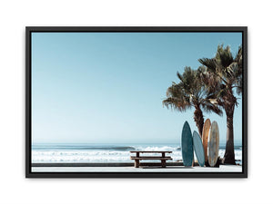Surfboards and palm trees beside the ocean in coastal modern beach house decor