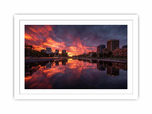 Dramatic city skyline canvas art with fiery sunset reflections for modern decor.