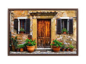 Bright rustic Mediterranean house facade wall art with vintage wooden doors, textured stone walls, and terracotta flower pots in airy natural daylight.