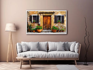Bright rustic Mediterranean house facade wall art with vintage wooden doors, textured stone walls, and terracotta flower pots in airy natural daylight.