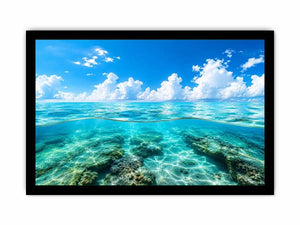 Bright split-view ocean wall art featuring crystal-clear turquoise water, underwater rock formations, and soft clouds beneath a vivid blue sky.