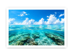 Bright split-view ocean wall art featuring crystal-clear turquoise water, underwater rock formations, and soft clouds beneath a vivid blue sky.