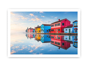 Bright colorful coastal village wall art featuring vibrant European houses reflected in calm water with soft fog and minimalist atmospheric tones.