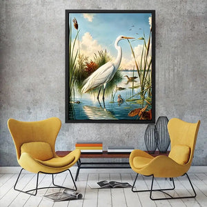Vintage white heron standing in tranquil marshland with soft blue sky and reeds coastal bird wall art canvas
