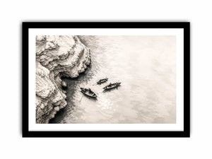 Minimalist coastal boat wall art with small rowboats beside rocky shoreline in monochrome sketch style