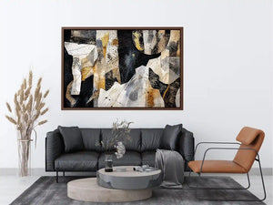Abstract collage artwork with black, white, and gold textures and layered paper elements