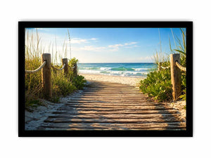 Wooden beach boardwalk leading through coastal dunes toward the ocean shoreline