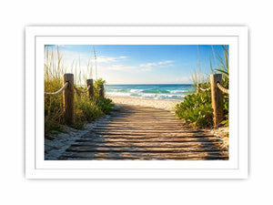 Wooden beach boardwalk leading through coastal dunes toward the ocean shoreline