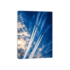 Modern jet formation wall art with airplane contrails against deep blue sky