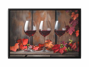 Three red wine glasses with autumn leaves and grapes for dining room decor.