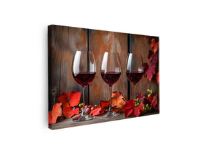 Three red wine glasses with autumn leaves and grapes for dining room decor.