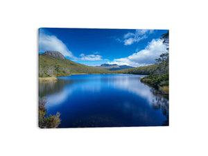 Serene mountain lake landscape with blue water and sky for modern living room wall art.