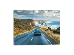 Coastal road trip artwork with vintage car and ocean cliffs for modern living room decor.