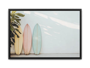 Pastel surfboards by a white wall for calm coastal bedroom decor.