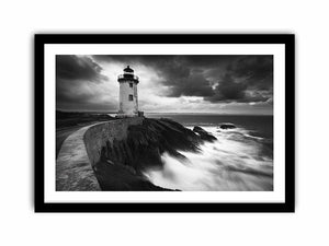 Moody black and white lighthouse wall art with storm clouds for modern living room decor.