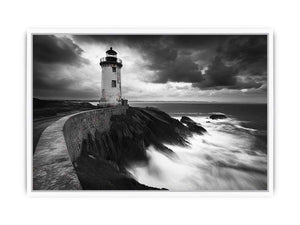 Moody black and white lighthouse wall art with storm clouds for modern living room decor.