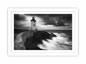 Moody black and white lighthouse wall art with storm clouds for modern living room decor.