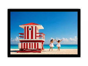 Minimal coastal beach scene with red lifeguard hut blue ocean and two women walking aesthetic wall art