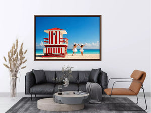 Minimal coastal beach scene with red lifeguard hut blue ocean and two women walking aesthetic wall art