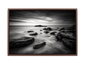 Black and white ocean wall art with dramatic coastal rocks, misty waves, and moody storm clouds in contemporary monochrome seascape style