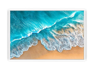 Aerial turquoise ocean beach canvas print with white foamy waves washing over sandy shore and tropical coastal water view