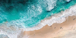 Aerial turquoise beach canvas art with ocean foam for modern coastal decor.
