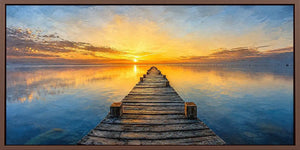 Sunset pier canvas print with calm water, wooden jetty and glowing horizon.