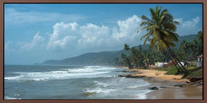 Tropical beach canvas art with palm trees, rolling surf and distant green hills.