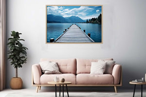 Calm lake jetty wall art with mountains for coastal living room decor.
