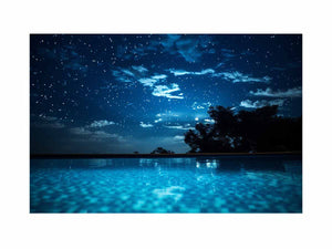 Celestial Pool Night star filled night sky above glowing turquoise pool water for modern home decor.