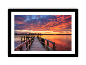 Sunset jetty canvas print with glowing water for modern living room decor.