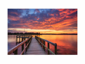 Sunset jetty canvas print with glowing water for modern living room decor.