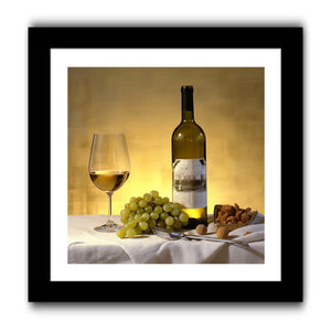 White wine bottle grapes and glass still life for dining room decor.