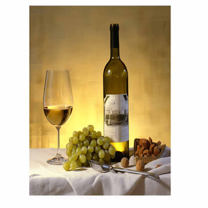 White wine bottle grapes and glass still life for dining room decor.